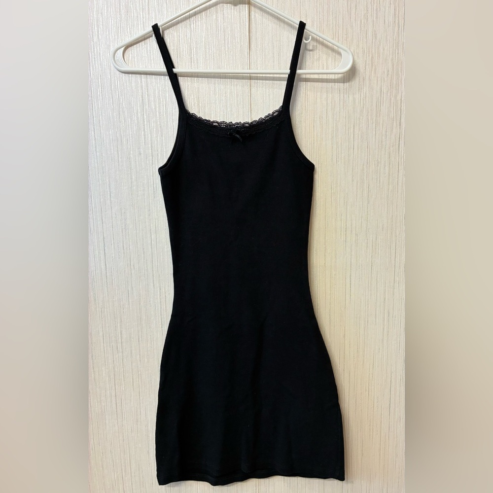 Melville Belle Lace Dress, a black ribbed cotton mini dress with a lace neckline